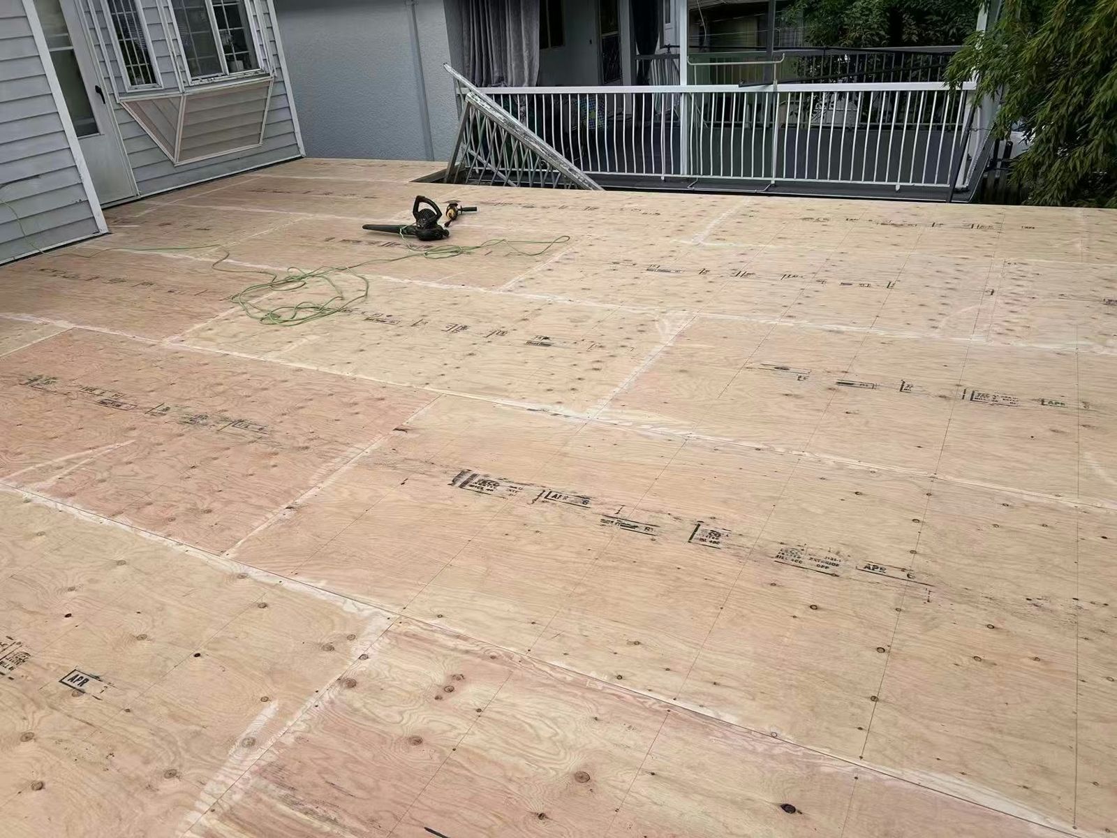 Before: Plywood sundeck to light grey vinyl
